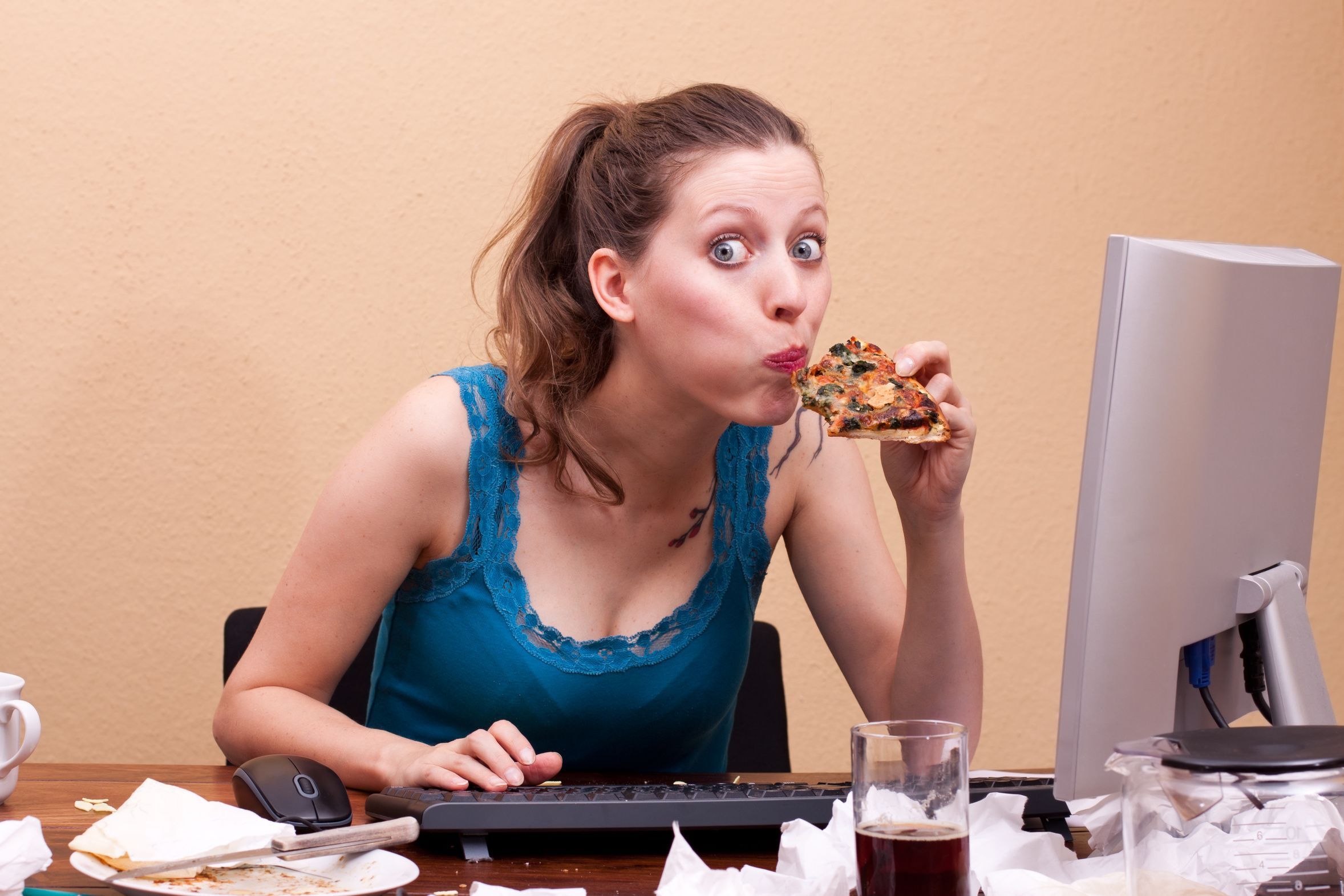 Женщины опасны для жизни. Человек ест за компьютером. Женщина ест за компьютером. Девушка в офисе кушает. Человек ест перед компьютером.