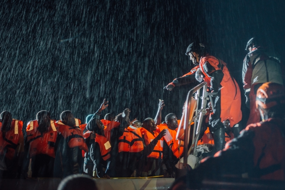 MSF and SOS Mediterannee Search and Rescue personnel operate in appalling conditions in the Mediterranean sea, 22 December 2016, as they help a boat in distress full of refugees and migrants off the northern coast of Libya.