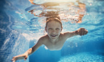παιδί κολυμπάει με τα μάτια ανοιχτά